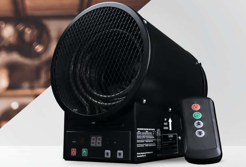 A black heater for garage use, with a remote control placed beside it