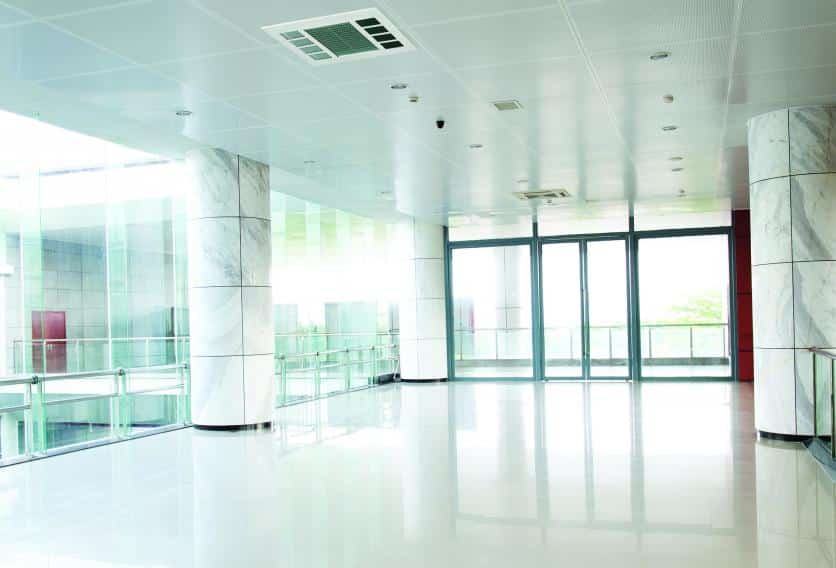 Empty office building with white walls and glass windows, showcasing modern design